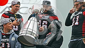 Ottawa Redblacks with Grey Cup during parade
